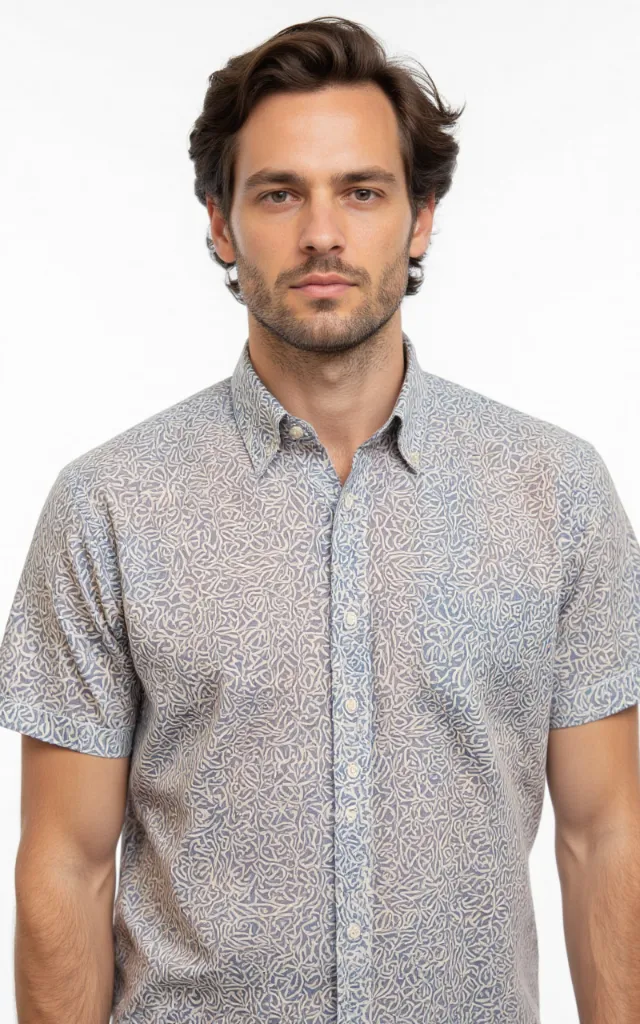 A French model wearing a Celtic pattern   printed shirt, against a white background, in a front   facing bust portrait
